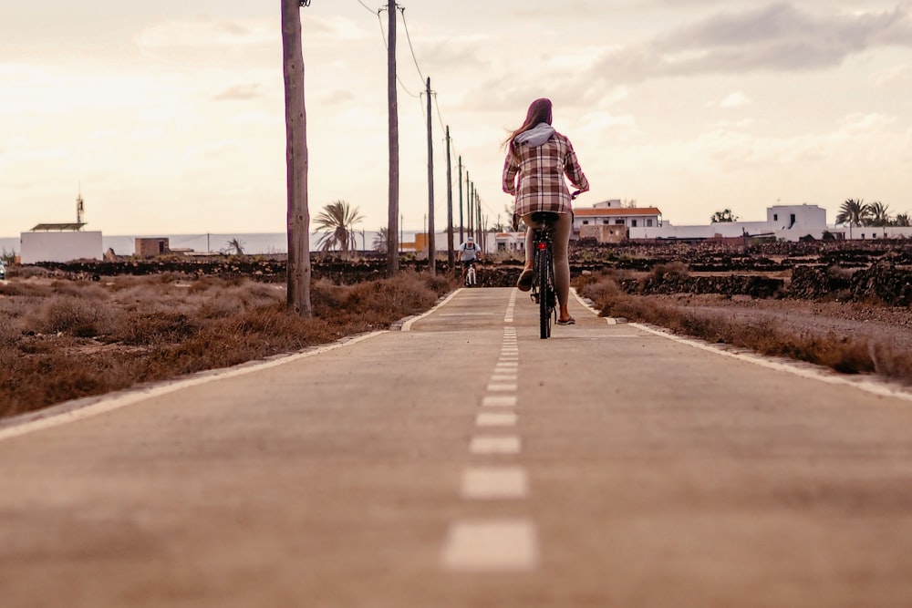 a person riding a bike down a street