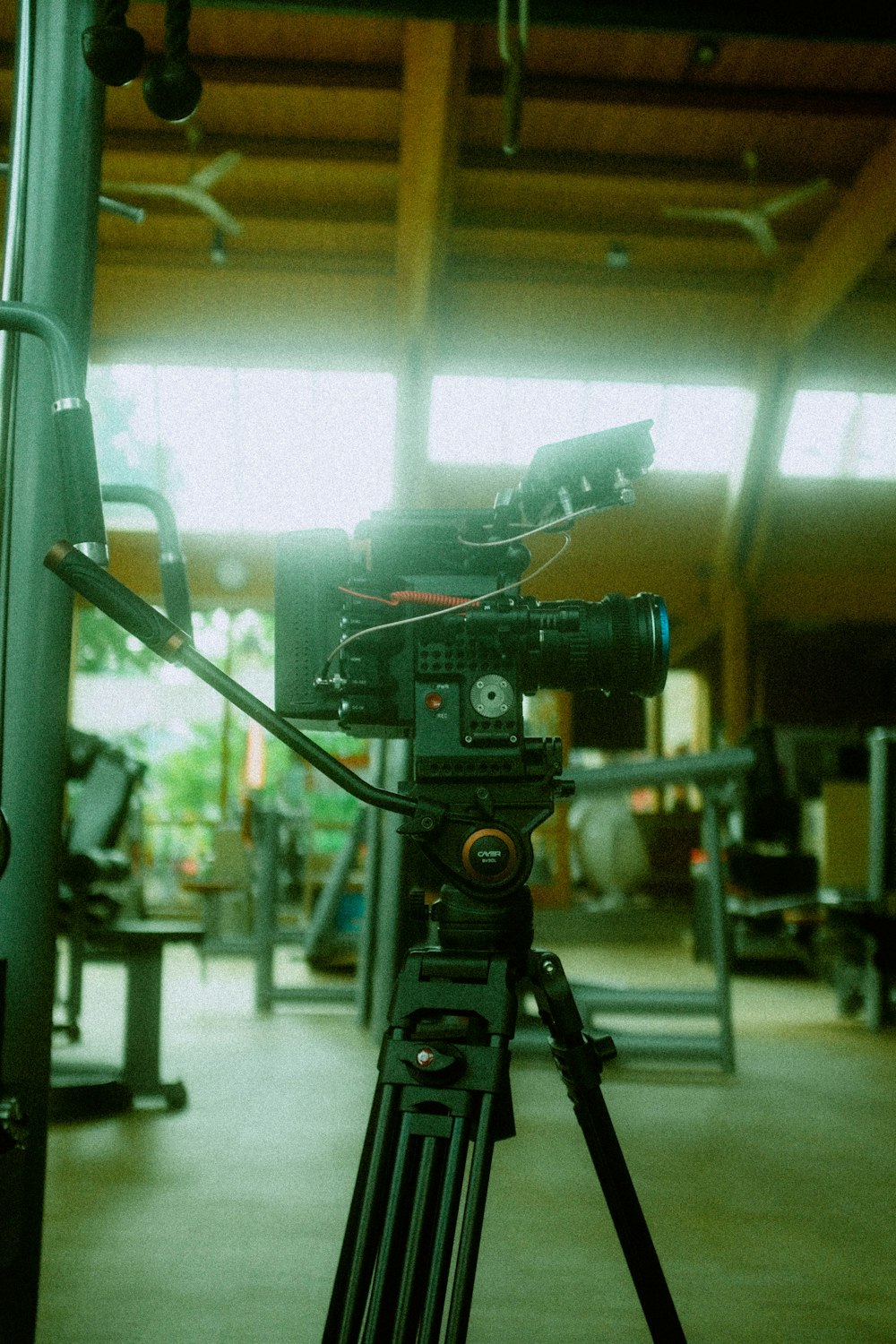 a camera set up on a tripod in a gym
