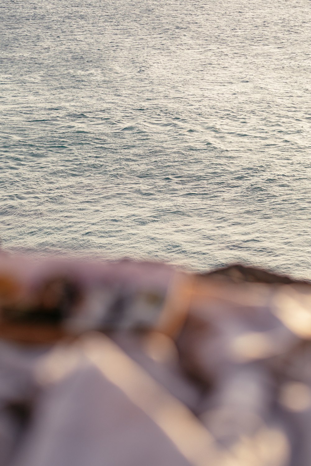 a man riding a surfboard on top of a body of water