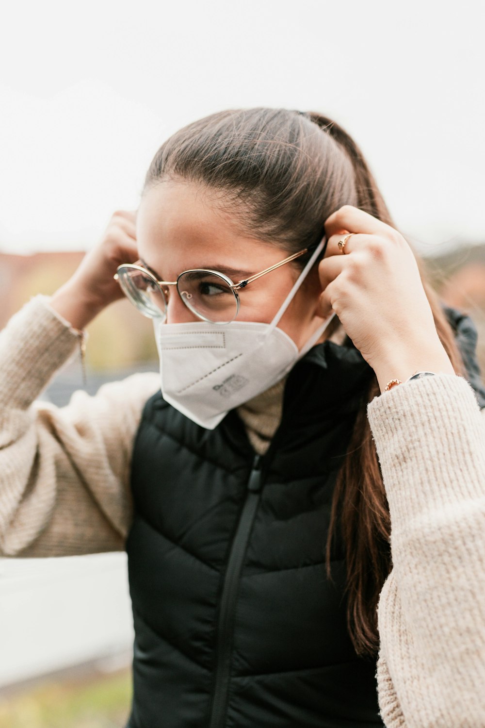 a woman wearing a face mask and glasses