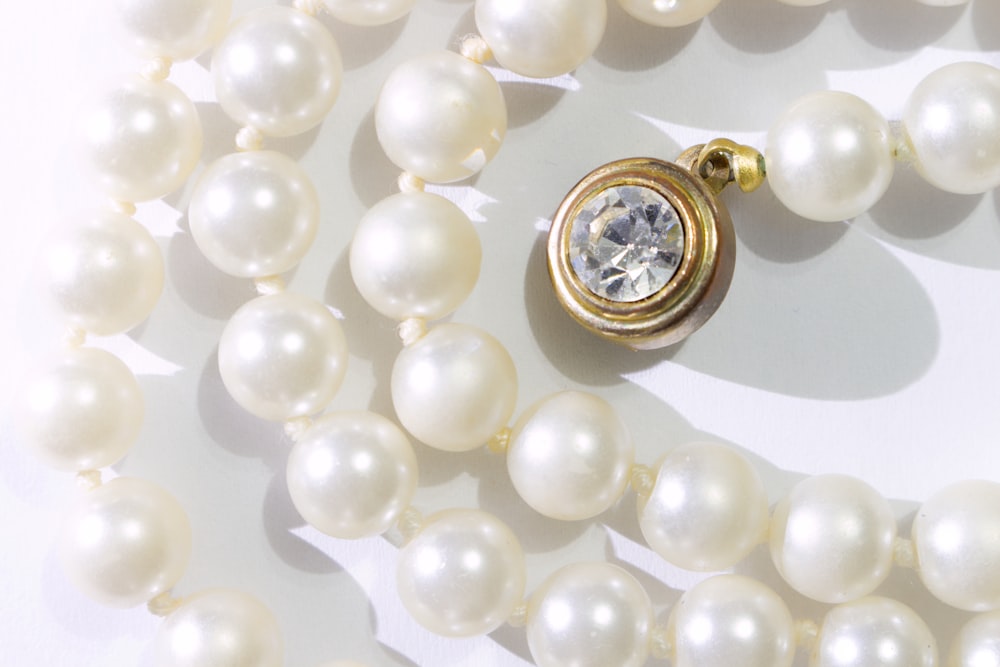 a necklace with a diamond surrounded by pearls