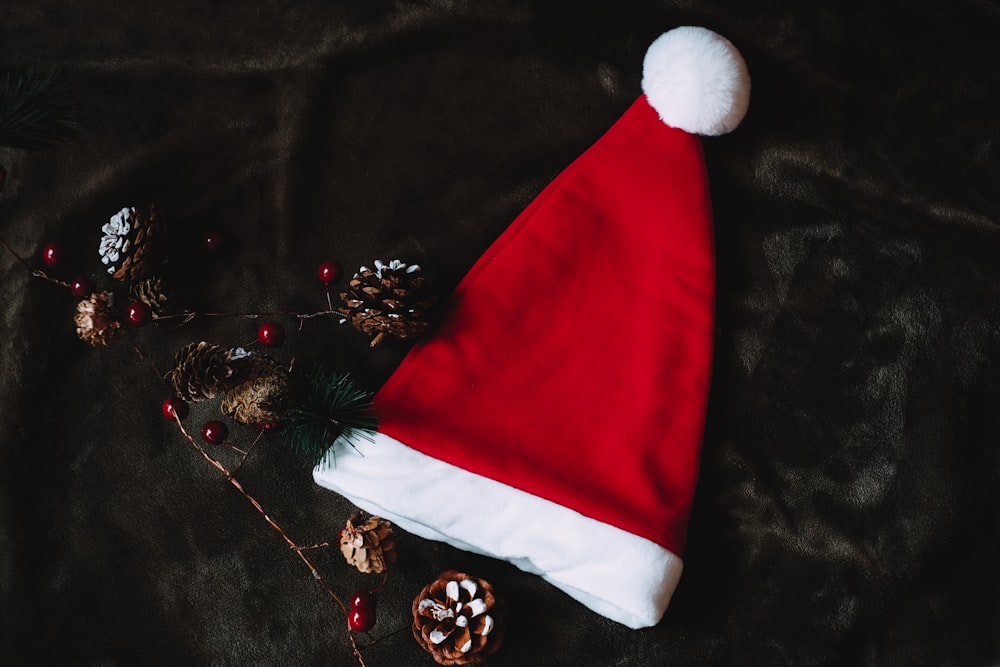 a red and white santa hat sitting on top of a table