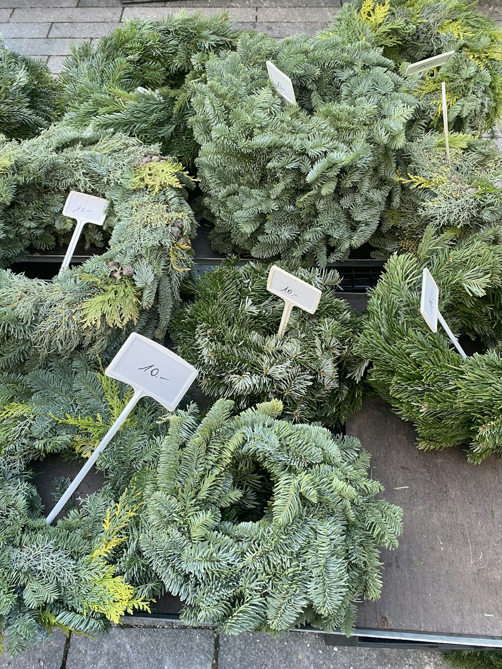 a bunch of wreaths that are sitting on the ground