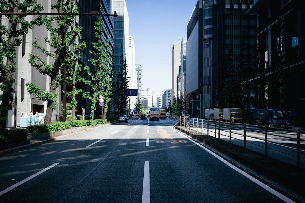 an empty street in a city with tall buildings