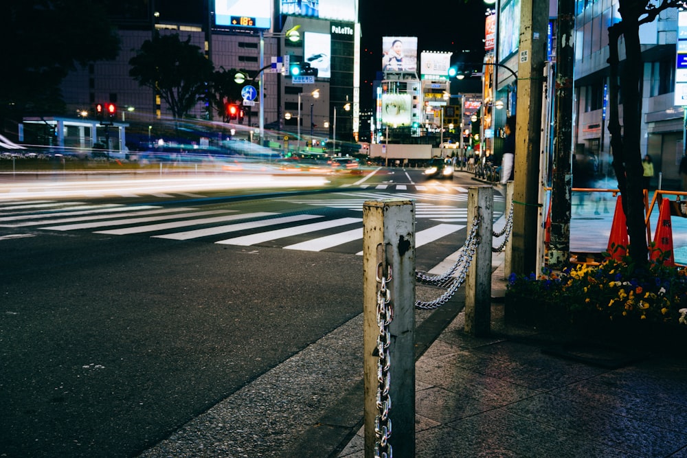 a city street at night with a parking meter