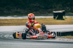 a person riding a go kart on a race track