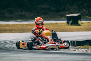 a person riding a go kart on a race track