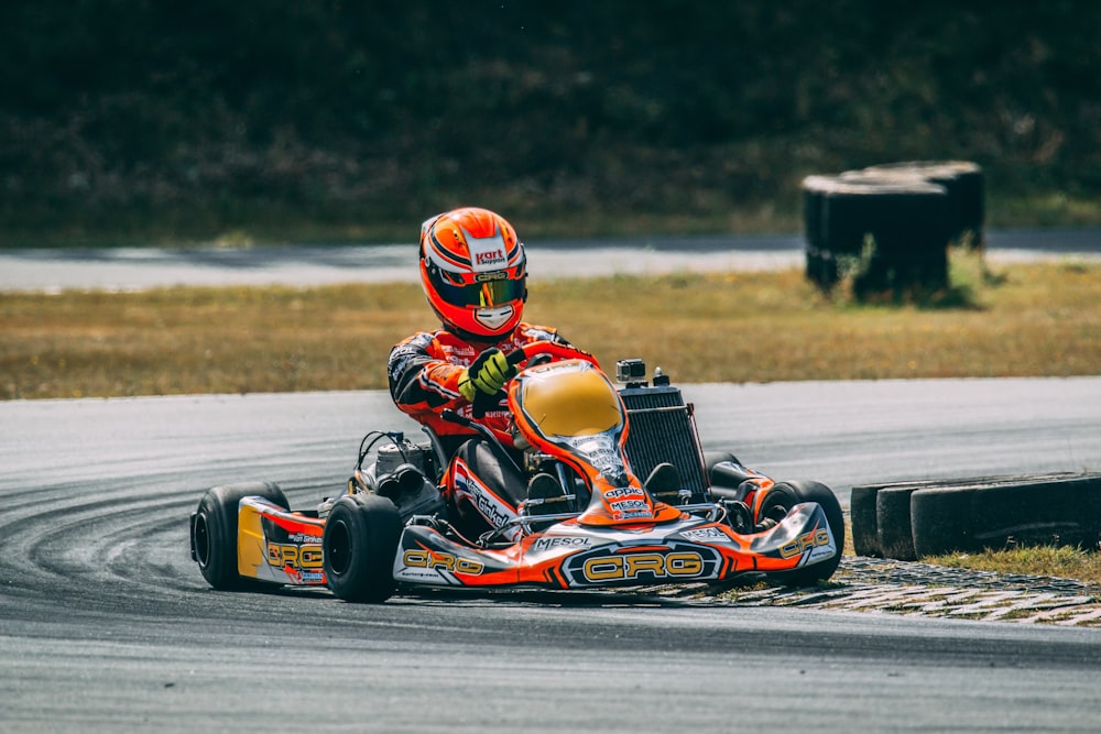 a person riding a go kart on a race track