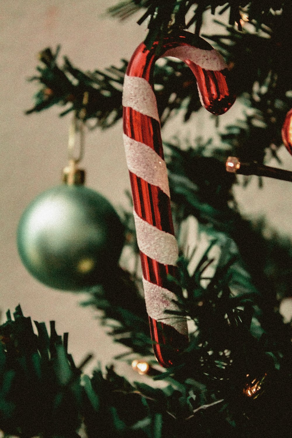 a candy cane hanging from a christmas tree