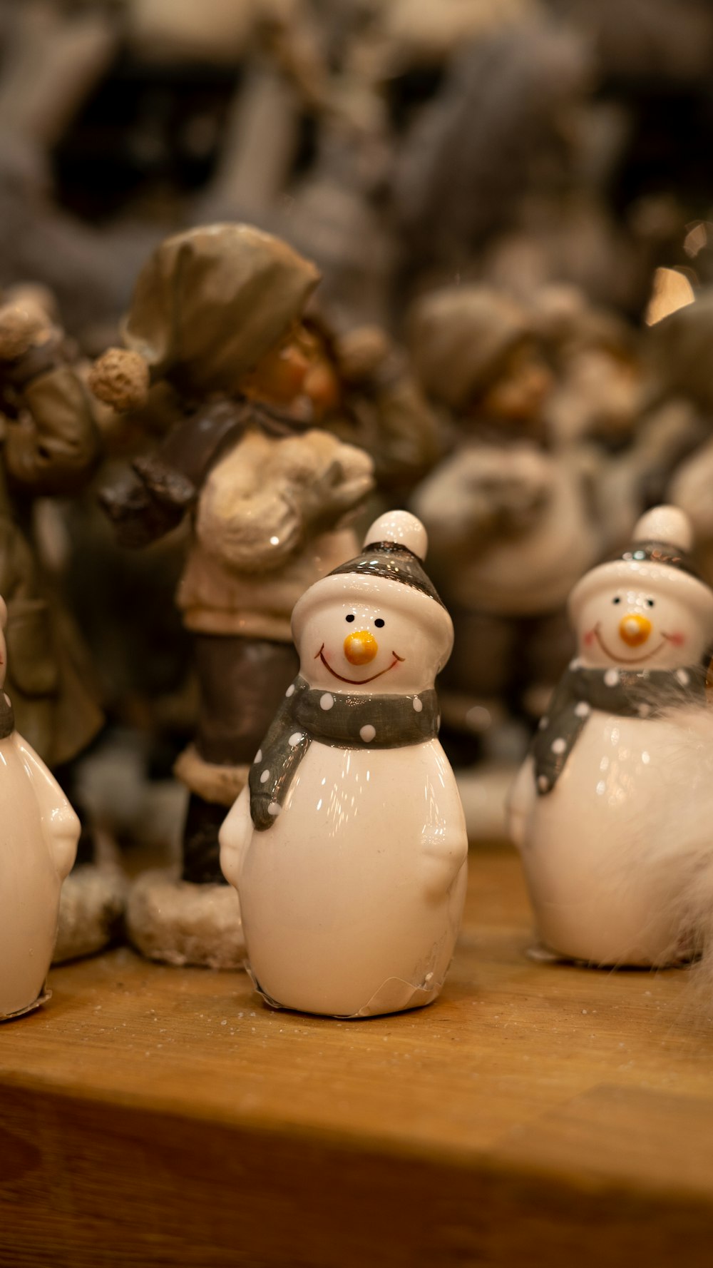 a group of snowmen sitting on top of a wooden table