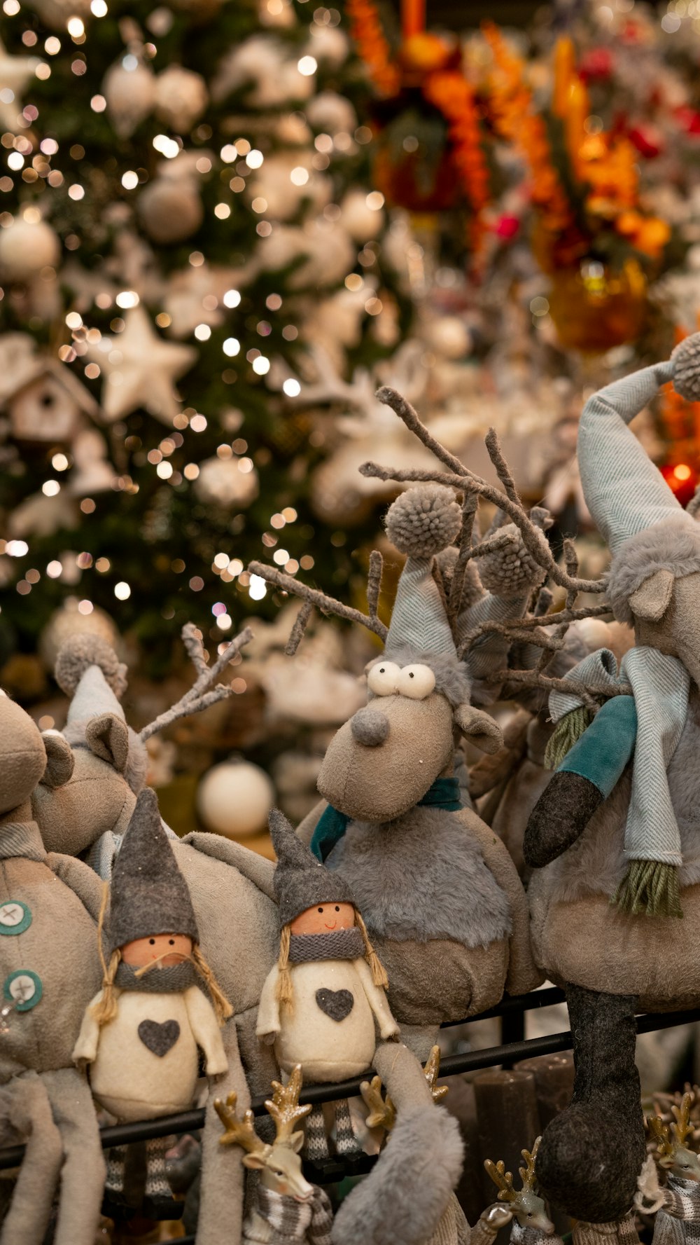 a group of stuffed animals sitting in front of a christmas tree