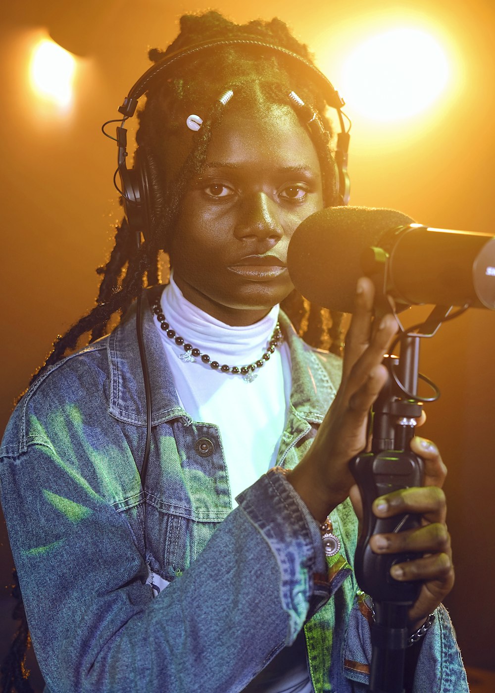 a woman with dreadlocks holding a microphone