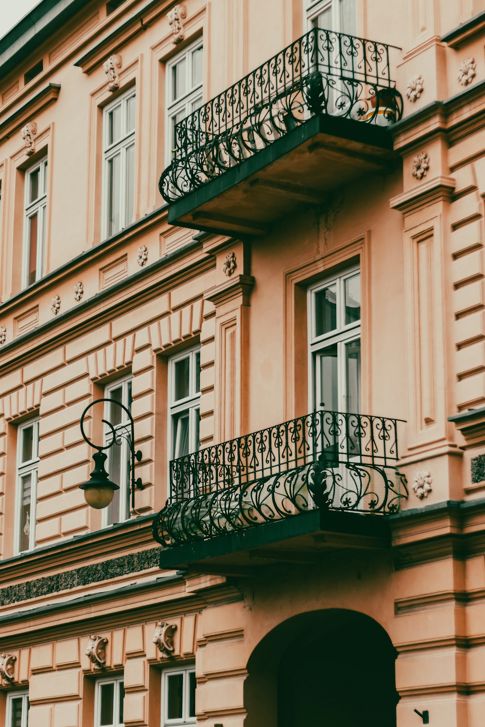 a building with a balcony and a clock on the front of it