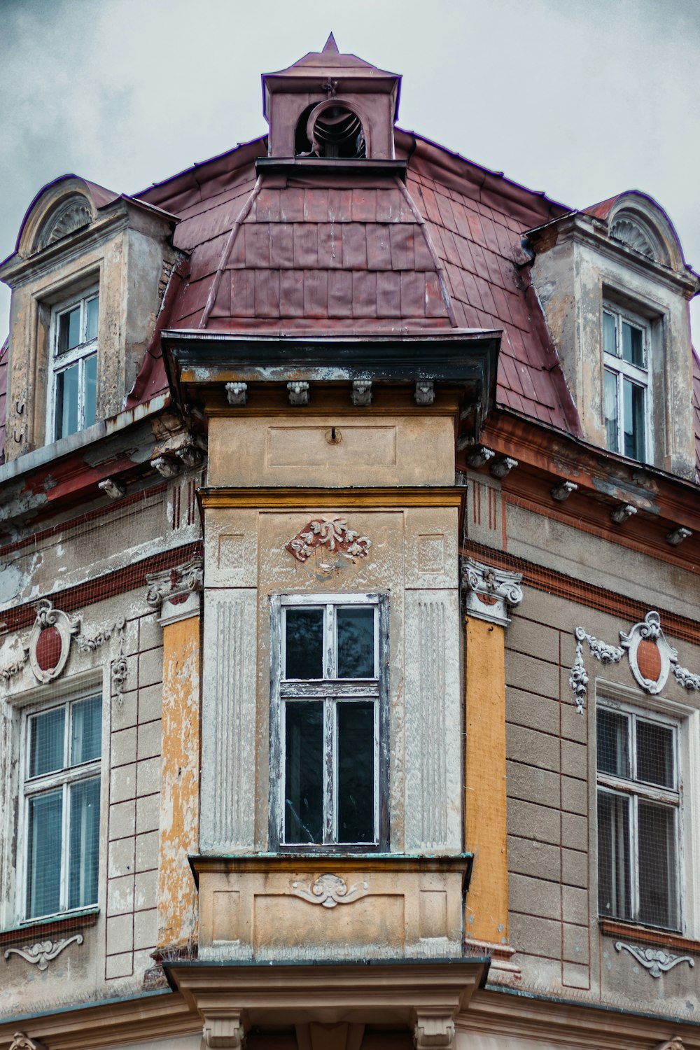 an old building with a clock on the top of it