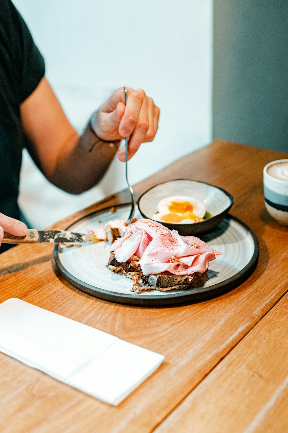 a person sitting at a table with a plate of food