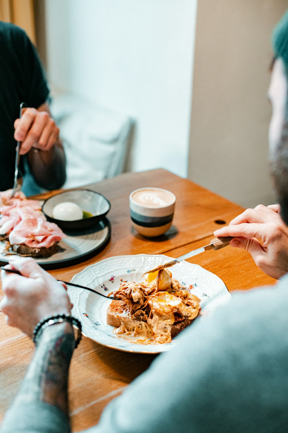 a man sitting at a table with a plate of food