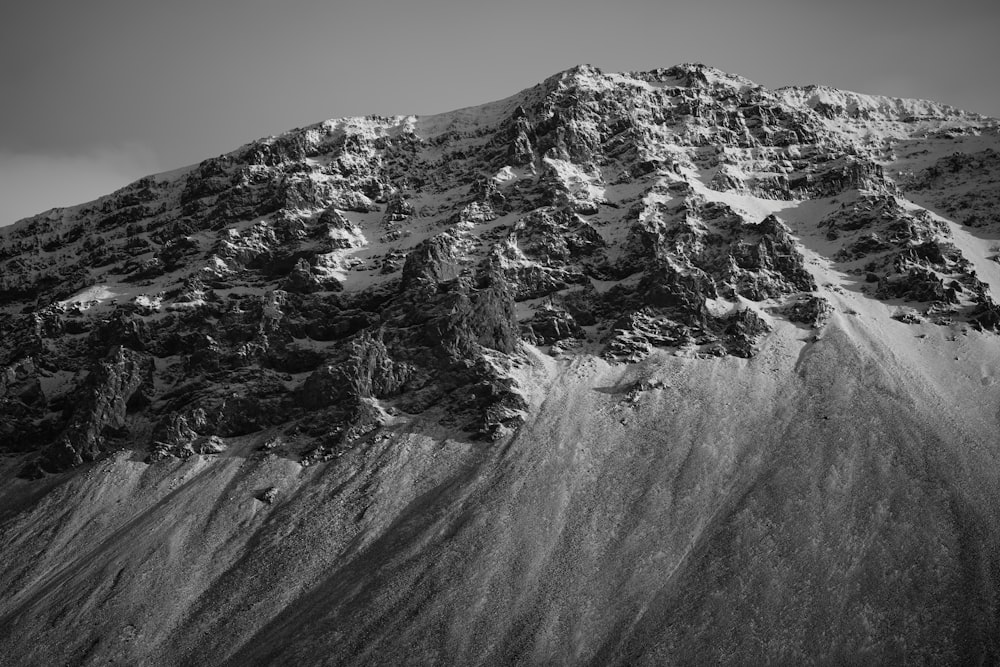 a black and white photo of a snow covered mountain