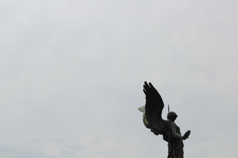 a statue of a man holding a bird in his hands