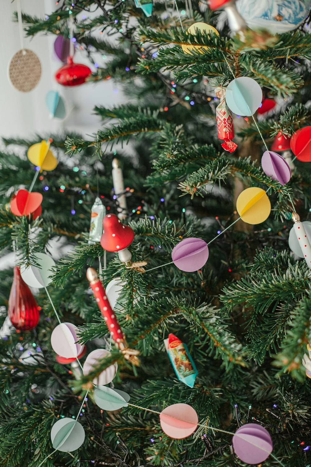 a christmas tree decorated with colorful paper ornaments