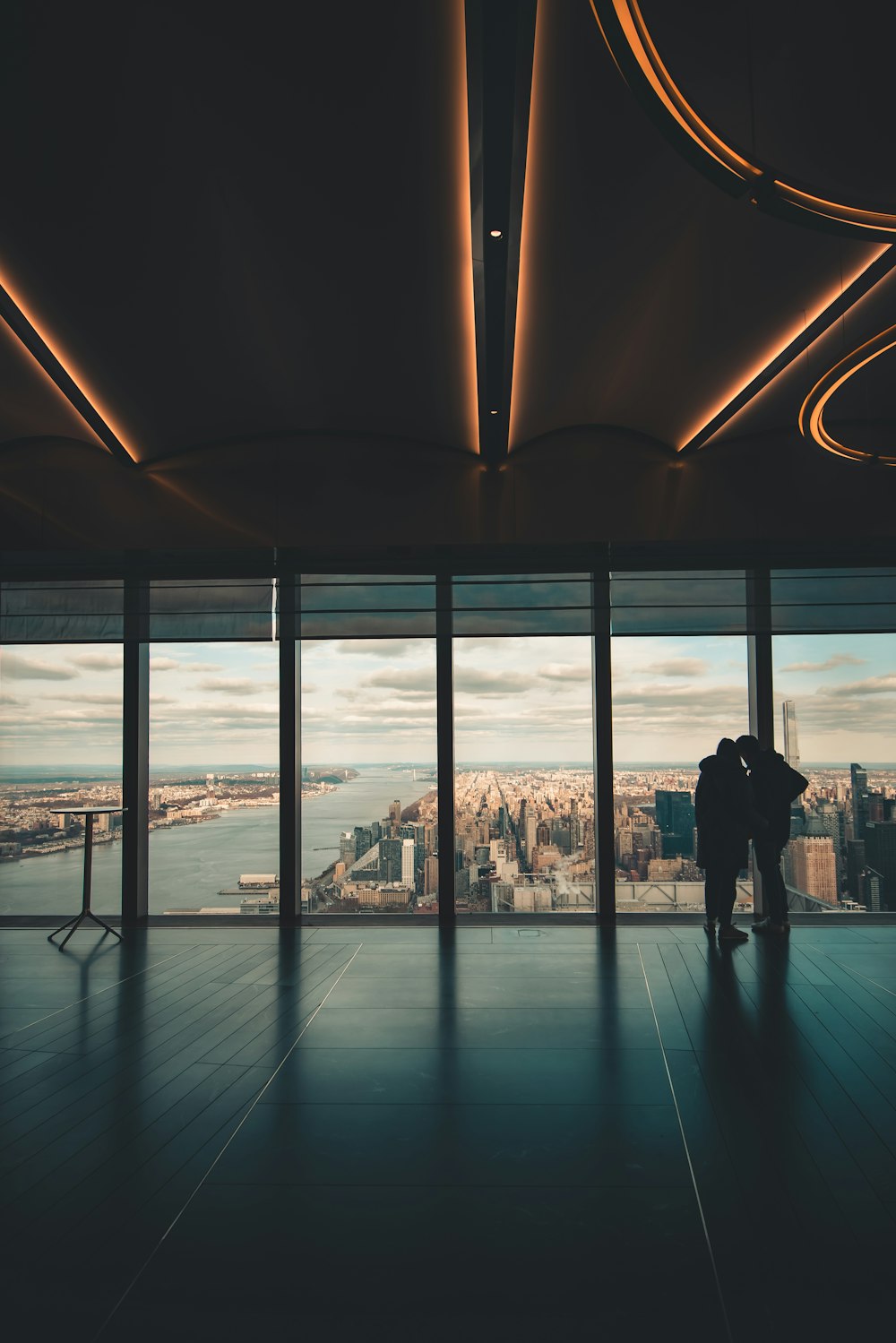 a couple of people standing in front of a window