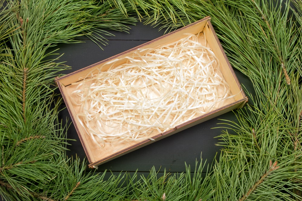 a box of shredded white paper sitting on top of a wreath