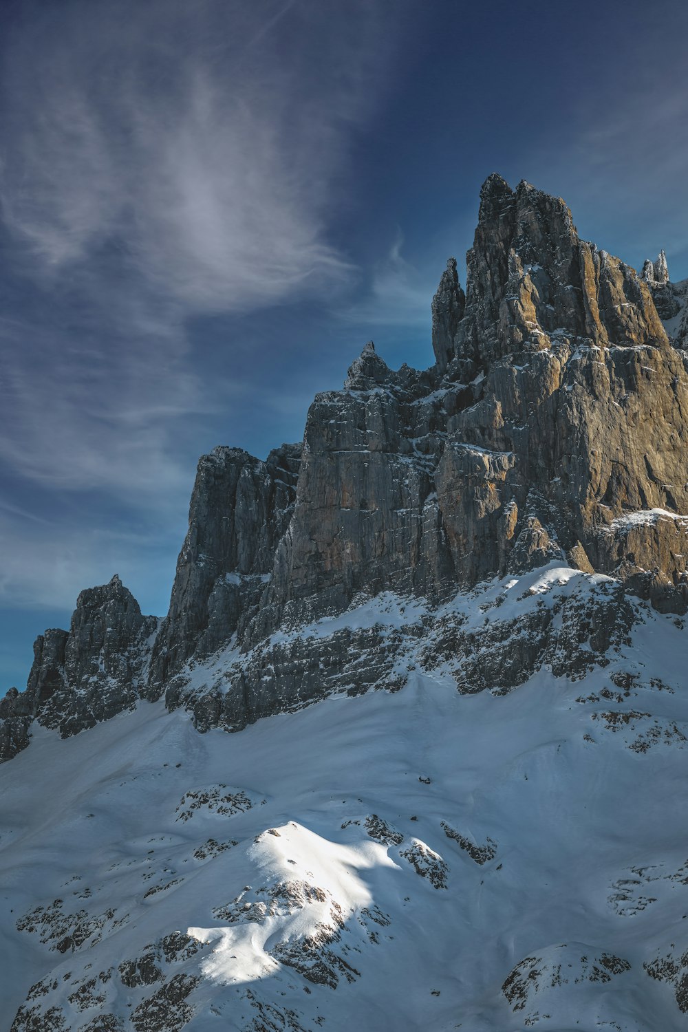 a snow covered mountain under a blue sky