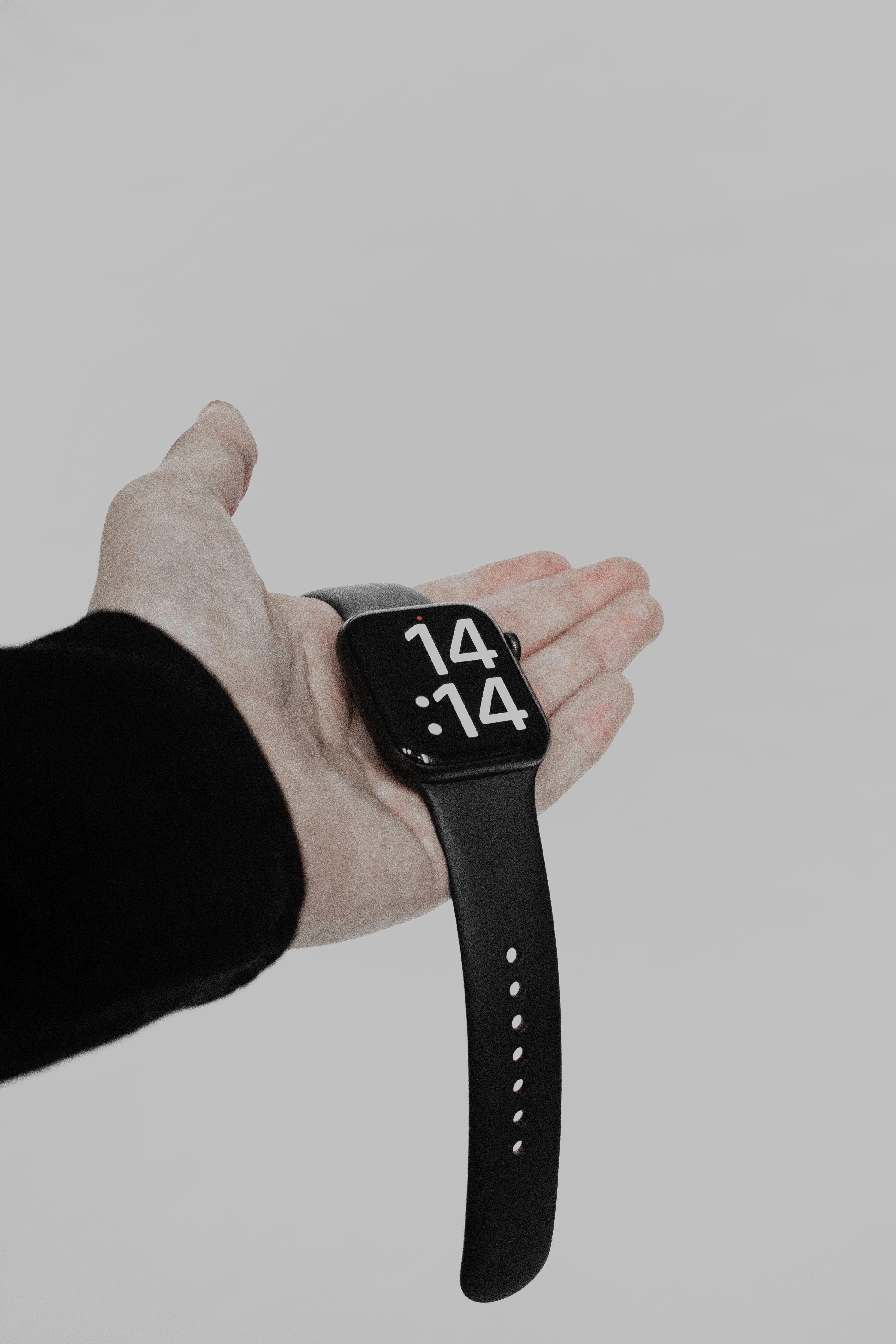 a person holding a smart watch in their hand