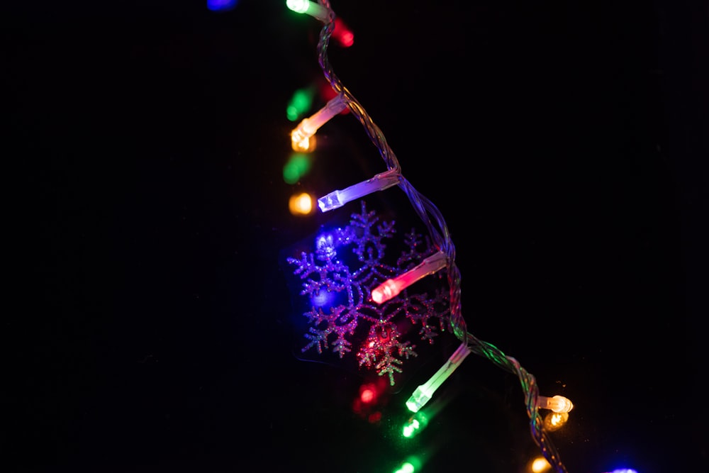 a string of christmas lights on a black background