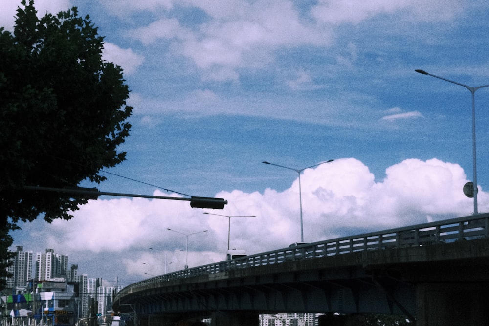 a traffic light hanging over a street next to a bridge