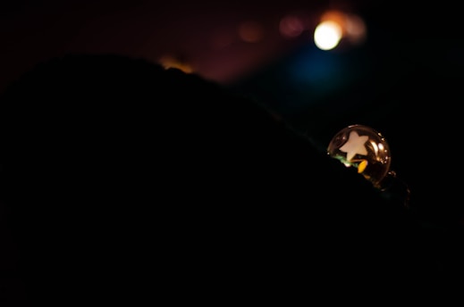 A glowing 3D orb displaying a family photo inside, set against a soft cream background.
