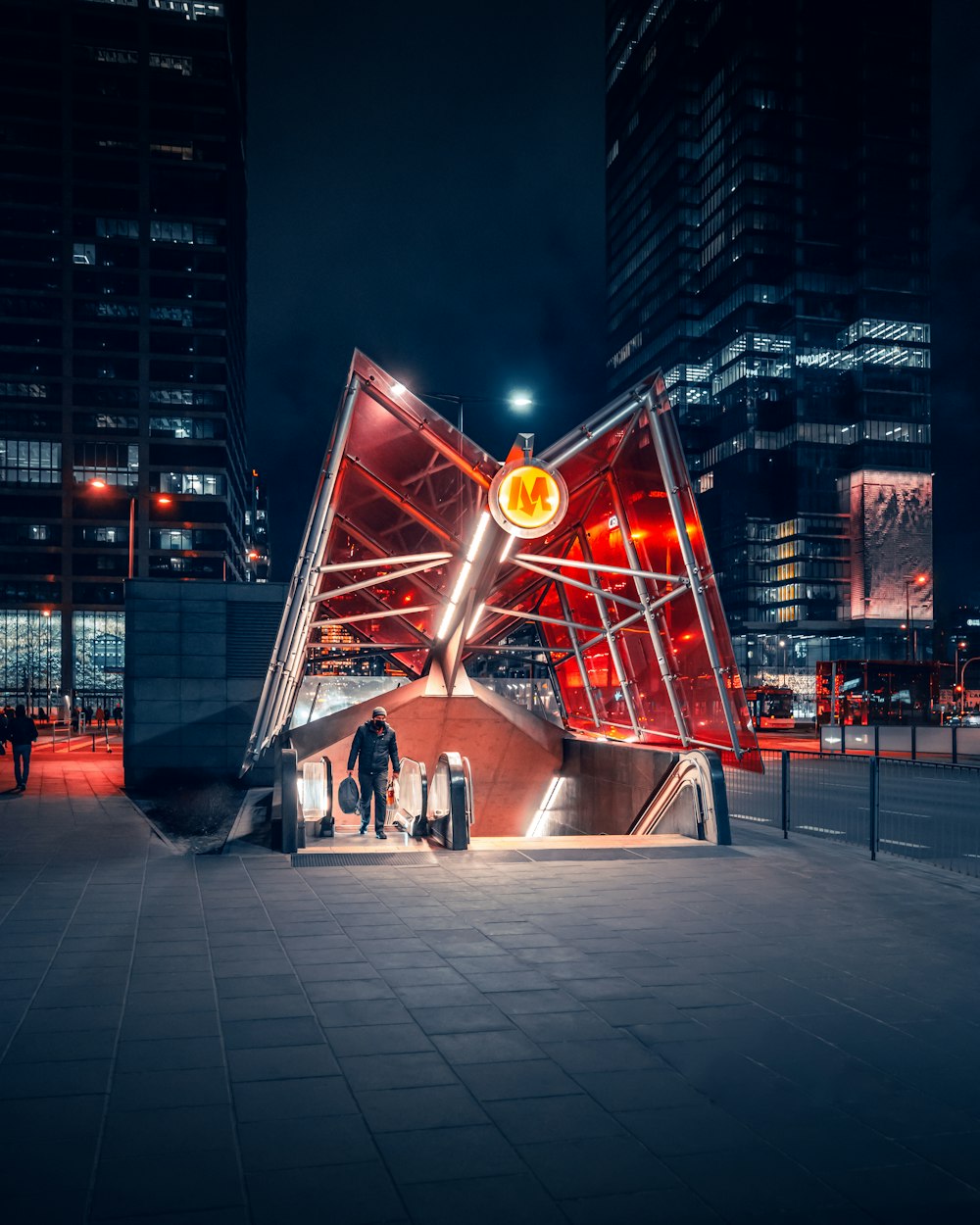 a group of people standing in front of a red structure