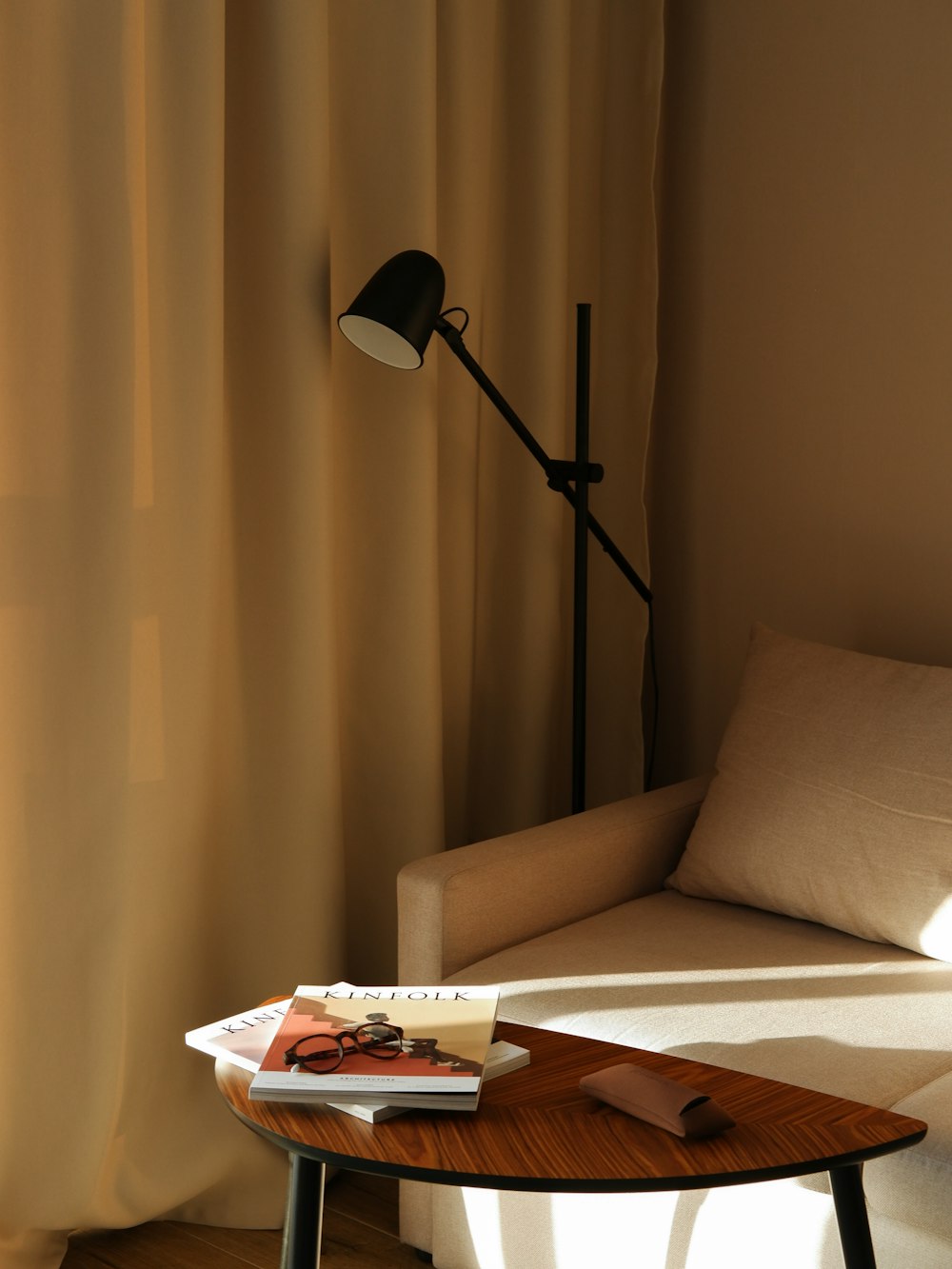a table with a book and a lamp on it