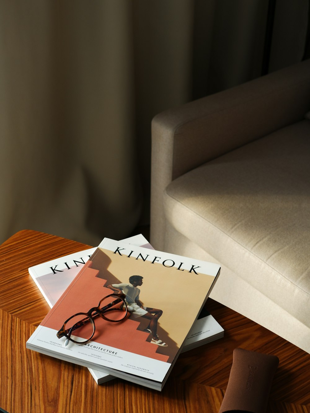 a pair of glasses sitting on top of a book on a table