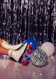 a person riding a roller skate next to a disco ball