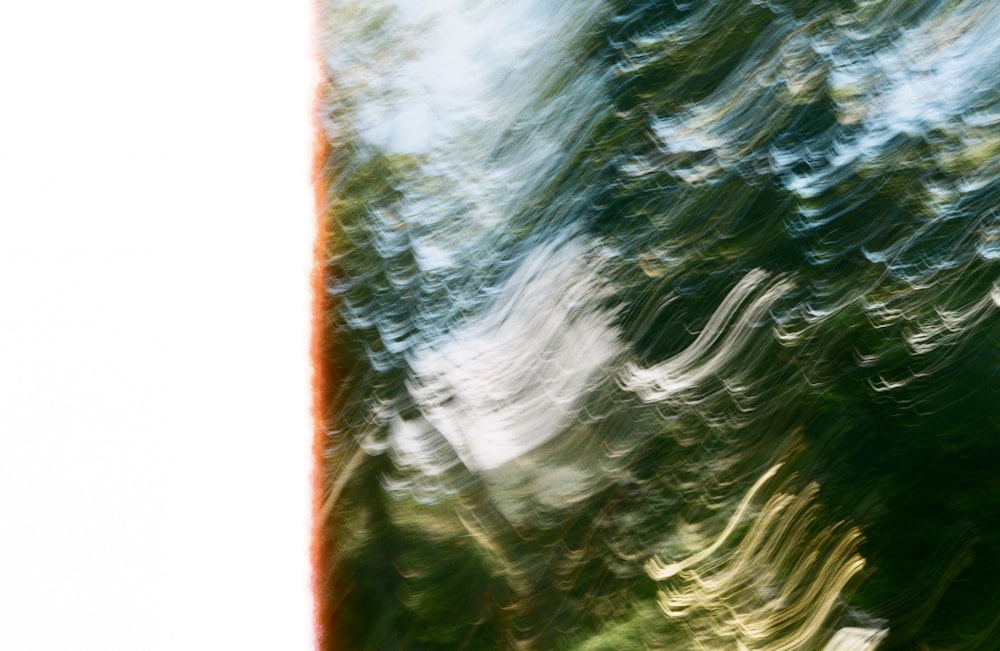 a blurry photo of a tree with a sky in the background