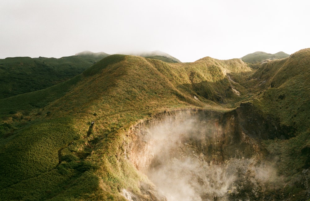 a view of a mountain with steam coming out of it