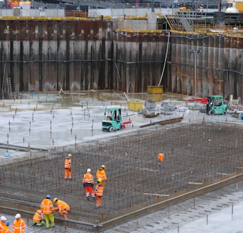 a group of construction workers standing around a construction site