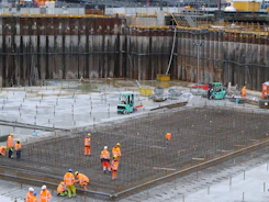 a group of construction workers standing around a construction site