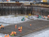 a group of construction workers standing around a construction site