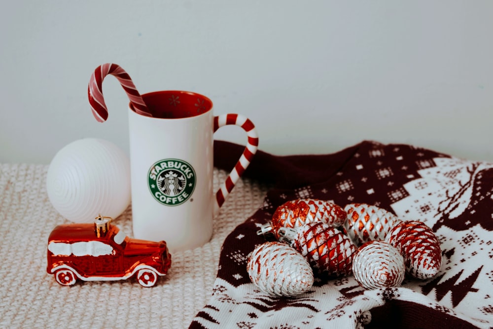 a cup of coffee next to some candy canes