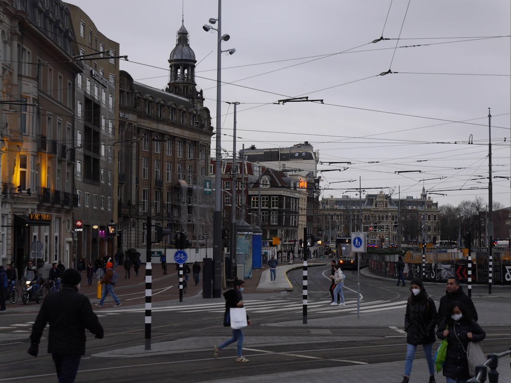 a group of people crossing a street at a crosswalk