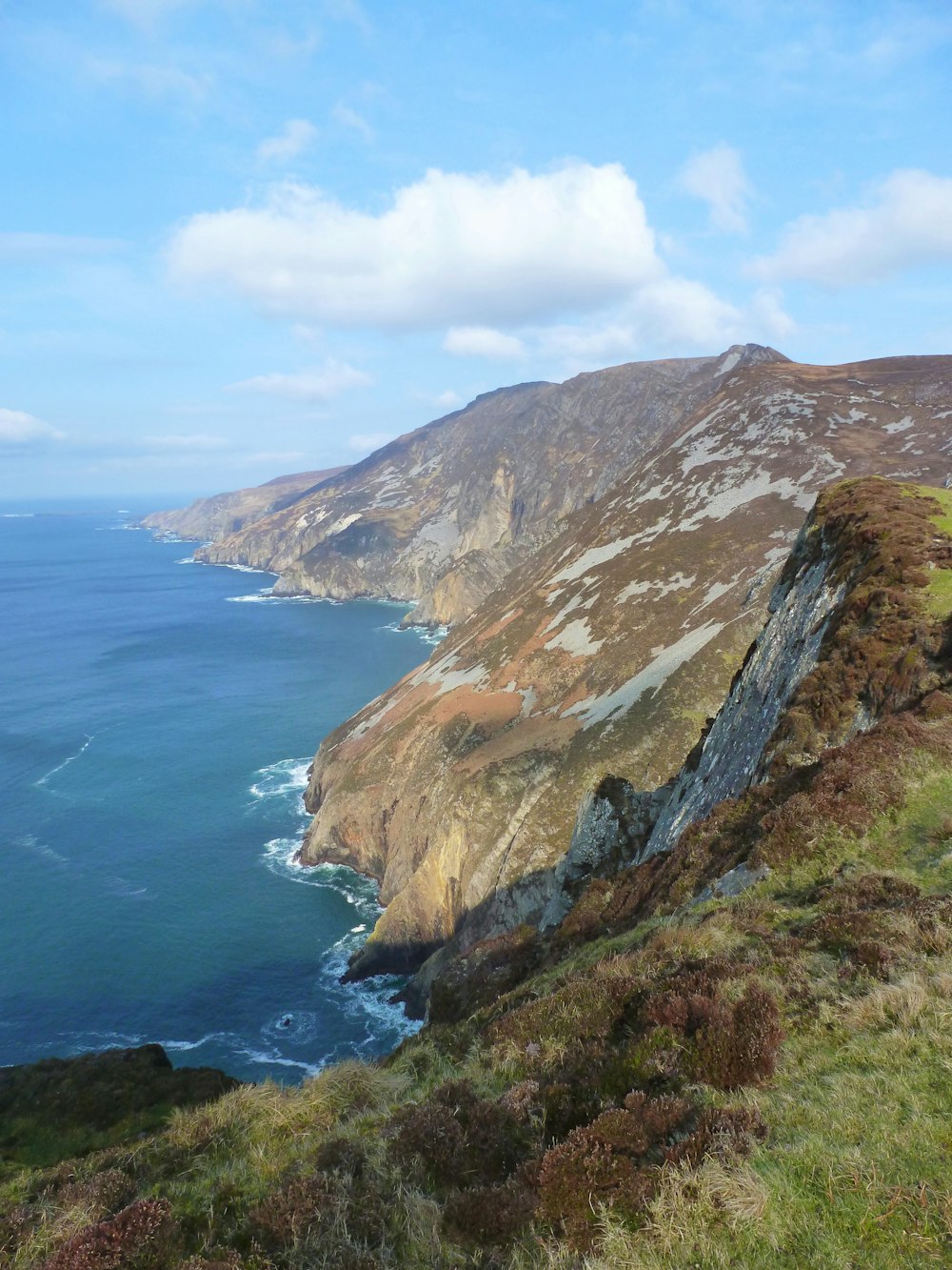 a view of the ocean from the top of a hill