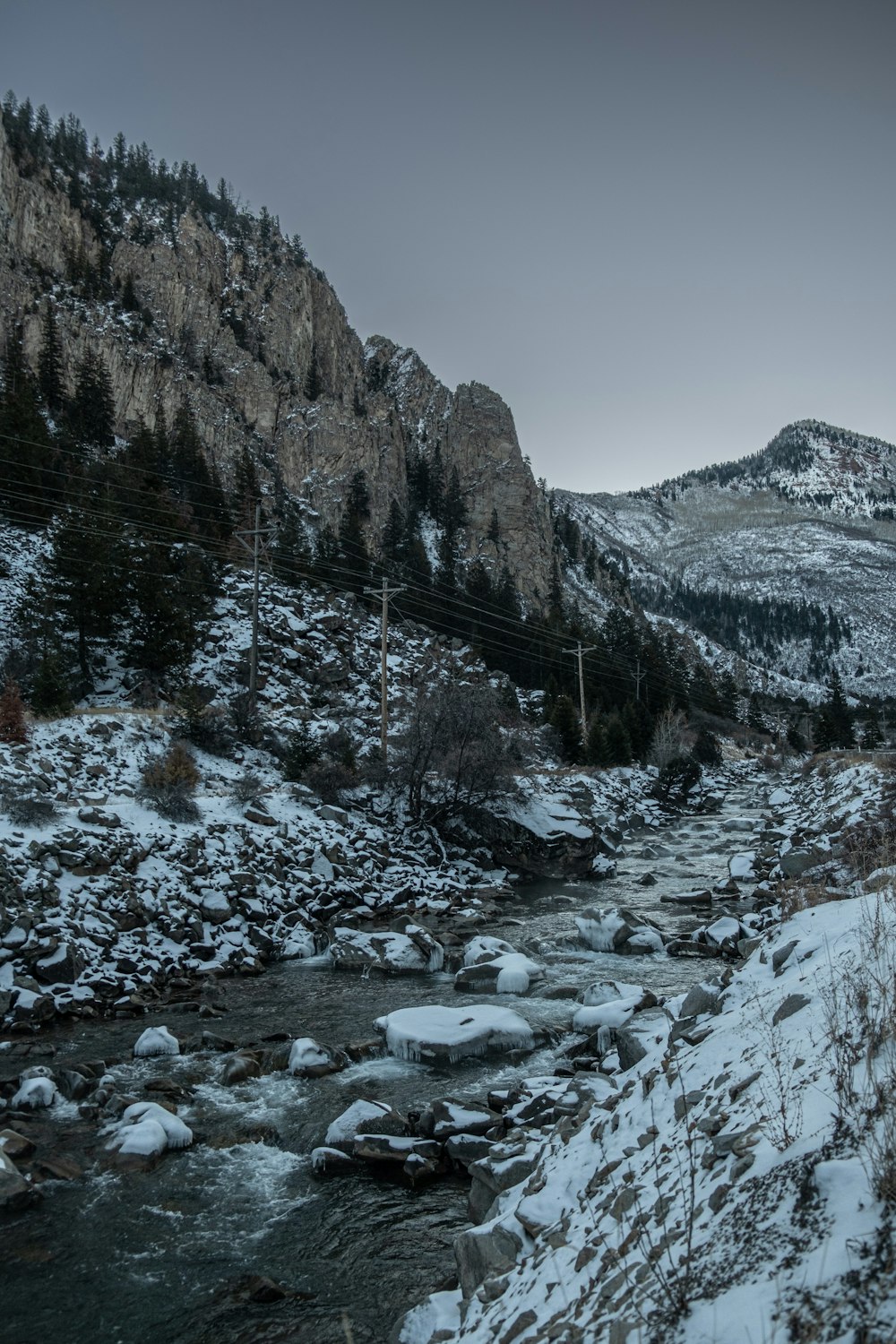 a river running through a snow covered forest