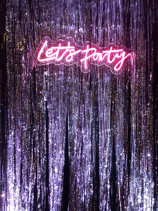 a neon sign that says let's party on it