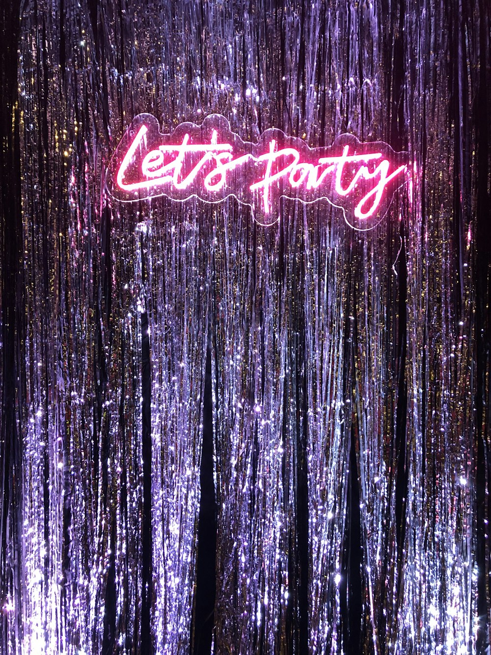 a neon sign that says let's party on it