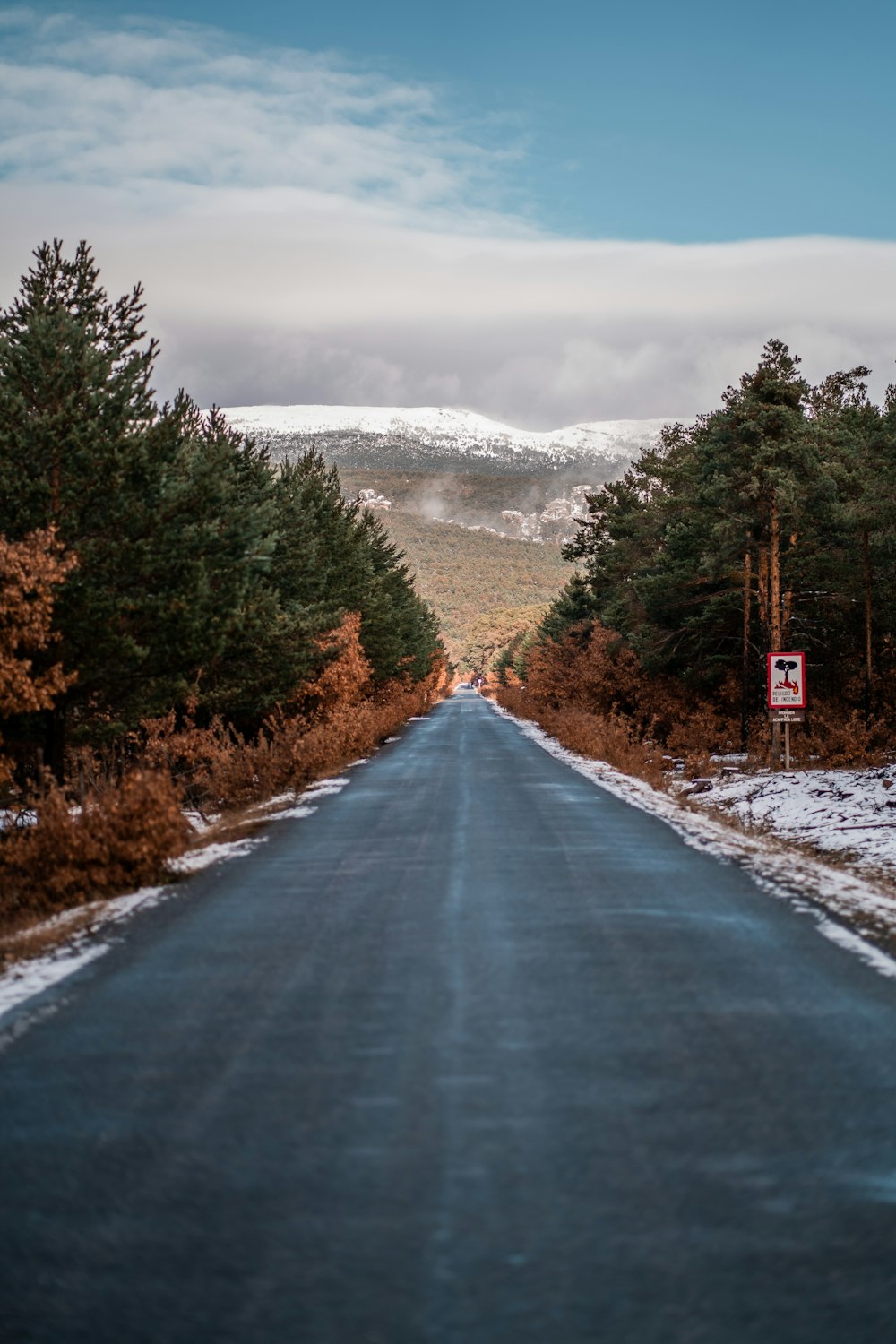 a long road with a sign on the side of it