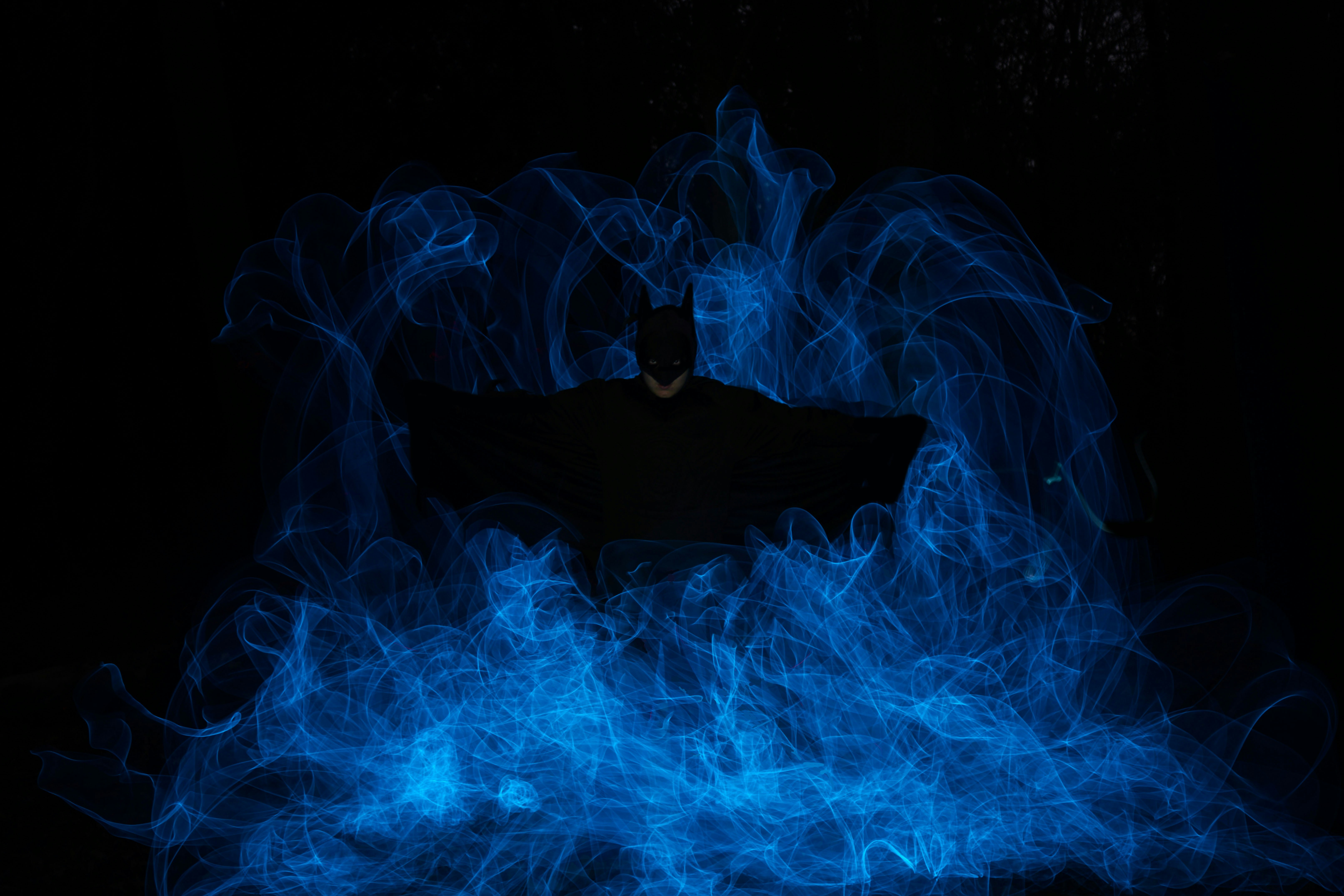 A man standing in the middle of blue smoke
