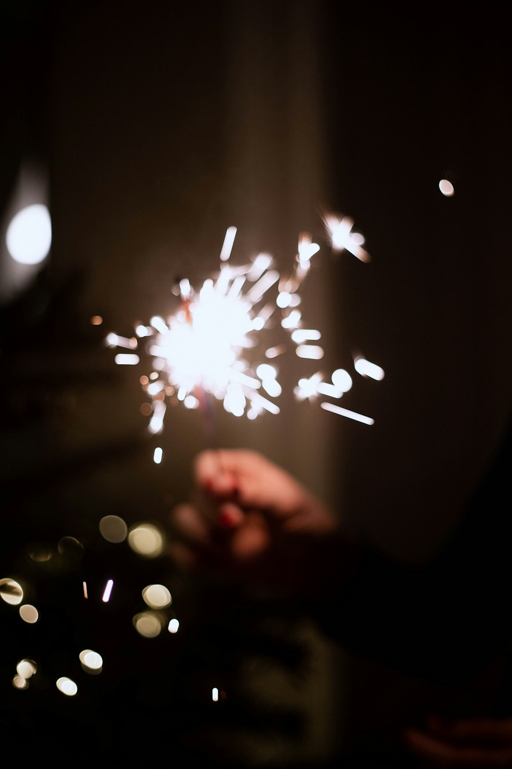 a person holding a sparkler in their hand