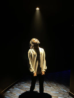 A candid photo of the actress rehearsing on stage under warm spotlight.