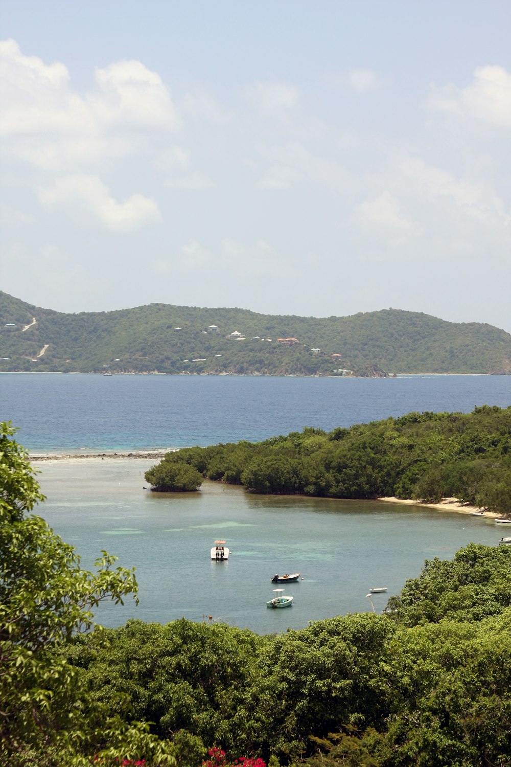 a large body of water with a mountain in the background